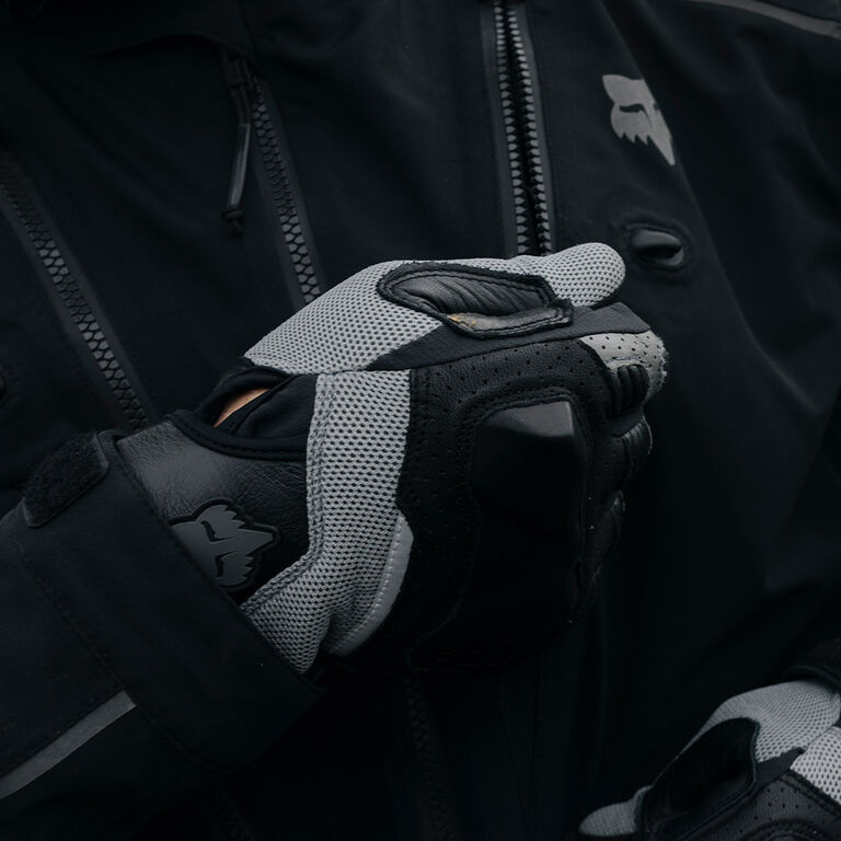 gloved hand zipping up an adv jacket